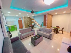 a living room with two couches and a table with a table at A05 SkyBlue Desa Tebrau in Johor Bahru