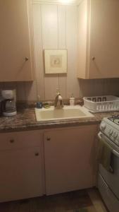 a kitchen with a sink and a stove at Cozy, cute beach condo in Westerly RI . Best value in Westerly!! in Westerly