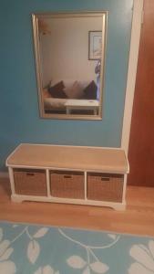 a mirror on a wall with a dresser in a room at Cozy, cute beach condo in Westerly RI . Best value in Westerly!! in Westerly