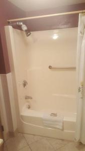 a bathroom with a white tub and a towel at Cozy, cute beach condo in Westerly RI . Best value in Westerly!! in Westerly