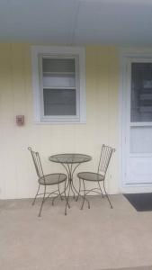 a table and two chairs with a table and a window at Cozy, cute beach condo in Westerly RI . Best value in Westerly!! in Westerly
