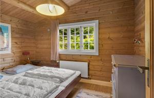 a bedroom with a bed and a window at Pet Friendly Home In Sams With Kitchen in Ballen