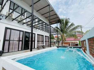 a large swimming pool in front of a house at B03 Larkin Bungalow Homestay in Johor Bahru