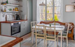 a kitchen with a table and chairs in a room at Nice Home In Ormaryd With Kitchen in Ormaryd
