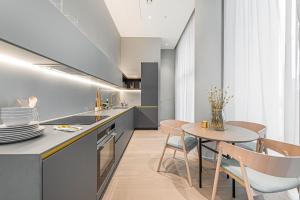 a kitchen and dining room with a table and chairs at The Cut- Stylish Riverside family home in London
