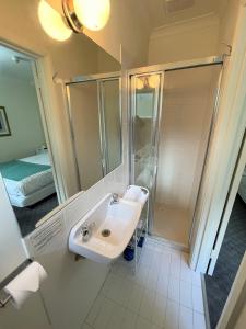 a bathroom with a sink and a shower at Panorama Retreat & Resort in Kalorama