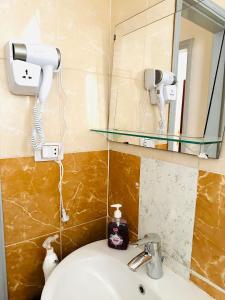 a bathroom with a sink and a mirror at RITA HOUSE SEA VIEW. Hurghada center in Hurghada