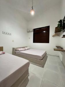 En eller flere senger på et rom på Casa Amarela Paripueira