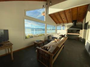 a living room with a couch and a large window at Lake in San Carlos de Bariloche