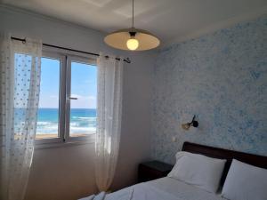A bed or beds in a room at Glyfada Beachfront Apartment A3g 58a