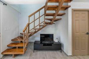 a staircase in a room with a tv and a door at Cozy Beach Villa at The Shores 5 minutes from the beach in West End