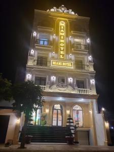 un gran edificio con un cartel en él por la noche en Khách sạn Miami Ninh Thuận en Phan Rang