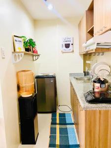 a kitchen with a small refrigerator in the corner at The Midpoint Residences in Mandaue City