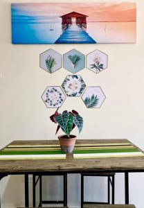 a table with a potted plant on a wall at The Midpoint Residences in Mandaue City