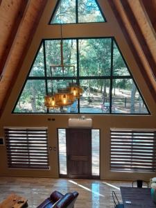 a large room with a large window and a chandelier at Deume alpina in Chillán