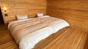 Postel nebo postele na pokoji v ubytování Genkai Ryokan