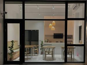 a kitchen with a table and chairs and a counter at Kenting Onehome in Checheng