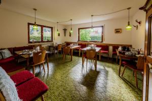 ein Esszimmer mit Tischen und roten Stühlen in der Unterkunft Gästehaus Döring in Mittenwald