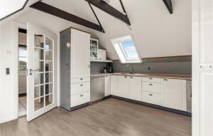 a kitchen with white cabinets and a window at Lovely Apartment In Hemmet in Hemmet