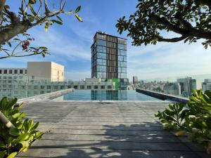 a swimming pool on the roof of a building at M City Hotel Saigon in Ho Chi Minh City