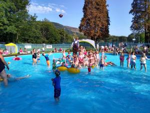 a large group of people in a swimming pool at Cottage by Rhigos Mountains in Treherbert