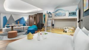 a childrens room with a bunk bed and a living room at Holiday Inn Express Xining Railway Station, an IHG Hotel in Xining
