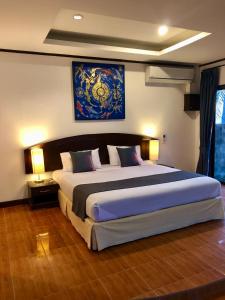 a bedroom with a large bed in a room at Noble House Beach Resort in Ko Lanta