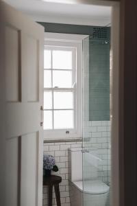 a bathroom with a toilet and a window at Dormie House in Moss Vale