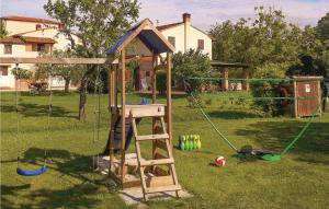 a wooden playset with a swing set in a yard at Fienile in San Giovanni Alla Vena