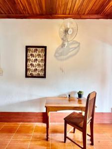 a dining room with a table and a fan at La Casa Hostel in Luang Prabang