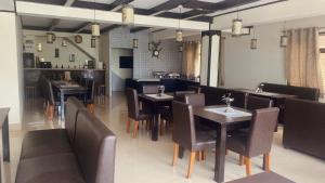 a dining room with tables and chairs in a restaurant at Lingmoo Residency in Ravangla