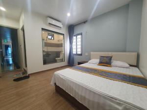 um quarto com uma cama grande e uma janela em Rosa Quỳnh Anh em Haiphong