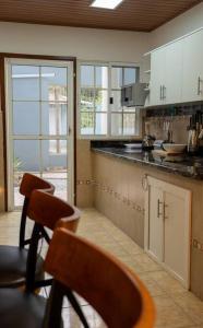 a kitchen with a counter and some chairs in it at Casa Privada en Siguatepeque in Siguatepeque