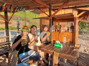 a group of people sitting at a table with drinks at Boneputeh Homestay in Taliwang +71 photos