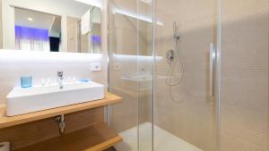 W łazience znajduje się umywalka i prysznic. w obiekcie Carducci Art Guesthouse w mieście Oristano
