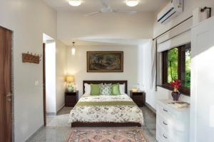 a bedroom with a large bed and a window at ama stays & trails - Dulwich Park View in Panchgani