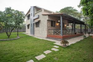 a house with a pavilion in the middle of a yard at ama stays & trails - Dulwich Park View in Panchgani