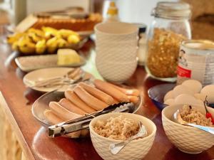 a table with hot dogs and eggs and other foods at AquaVilla in Vashafaru