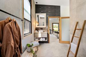 a bathroom with a sink and a mirror at Gan Eden Retreat-Byron bay , luxuries escape in Mullumbimby