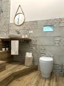 a bathroom with a white toilet and a sink at Il Moro in Carini