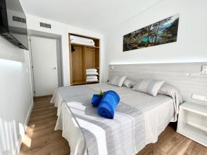 Ein Bett oder Betten in einem Zimmer der Unterkunft Aparthotel Ciudad Laurel