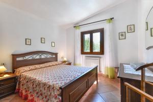 a bedroom with a large bed and a window at Casa Neda in Procchio