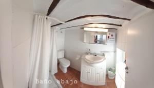 a white bathroom with a sink and a toilet at Casa del Puente in Nerpio +28 photos