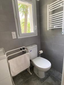a bathroom with a white toilet and a window at Casina Calenzana in Calenzana