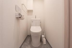 a small bathroom with a toilet in a stall at Casa Blan in Tokyo