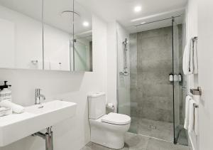 a bathroom with a toilet and a sink and a shower at Rambla at Perry House in Brisbane +20 photos