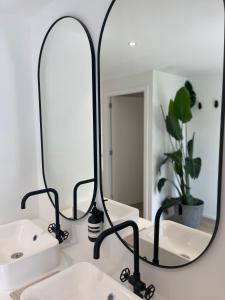 a bathroom with two sinks and a mirror on a counter at Chez Arthur in Marche-en-Famenne +23 photos