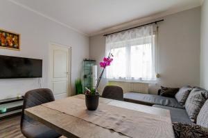 a living room with a table and a couch at Pannónia Szentendre in Szentendre