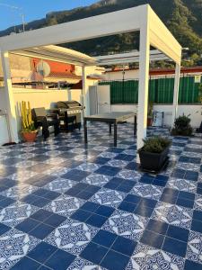 een patio met een blauwe en witte tegelvloer bij Coralinehaven in Castellammare di Stabia