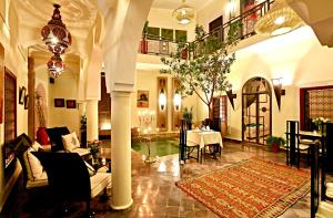 a large living room with a table and chairs at Riad Jardin Des Rêves in Marrakesh